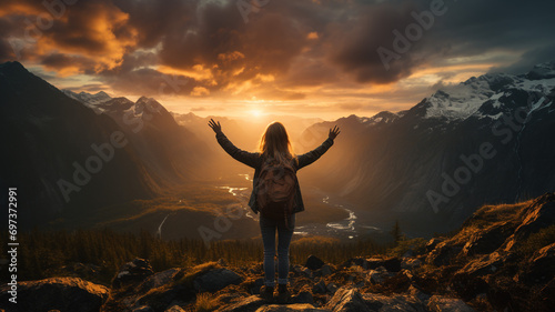 Atop the mountain peak  a victorious adventurer stands with arms outstretched looking to view