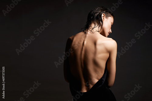 Naked Female back. young wet woman in the towel. Beautiful sexy Girl photo