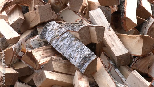 Dry split birch wood for the fireplace, stove, fire. Harvesting firewood for the winter. Large pile of firewood. Birch wood for heating in fireplaces and furnaces photo