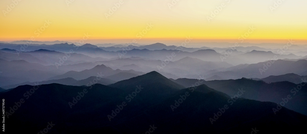 Silhouettes of the Serra da Mantiqueira's mountain range during sunset, seen from Marins Peak. Piquete, Sao Paulo, Brazil