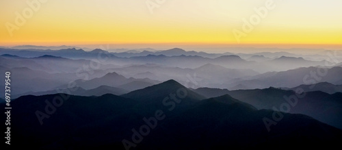 Silhouettes of the Serra da Mantiqueira's mountain range during sunset, seen from Marins Peak. Piquete, Sao Paulo, Brazil photo
