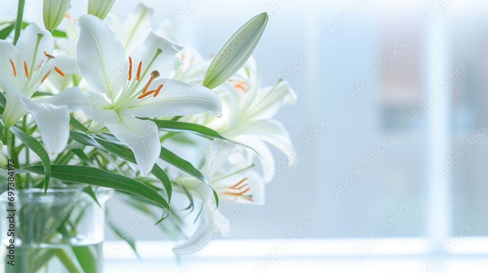  a vase filled with white lilies sitting on top of a window sill next to a window sill.