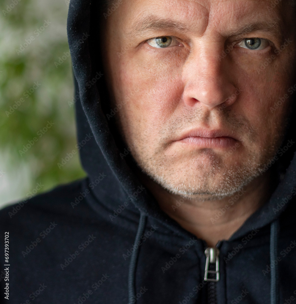 Man looked like hacker in a hood looking at the screen. People Man looked like hacker in a hood looking at the screen. People