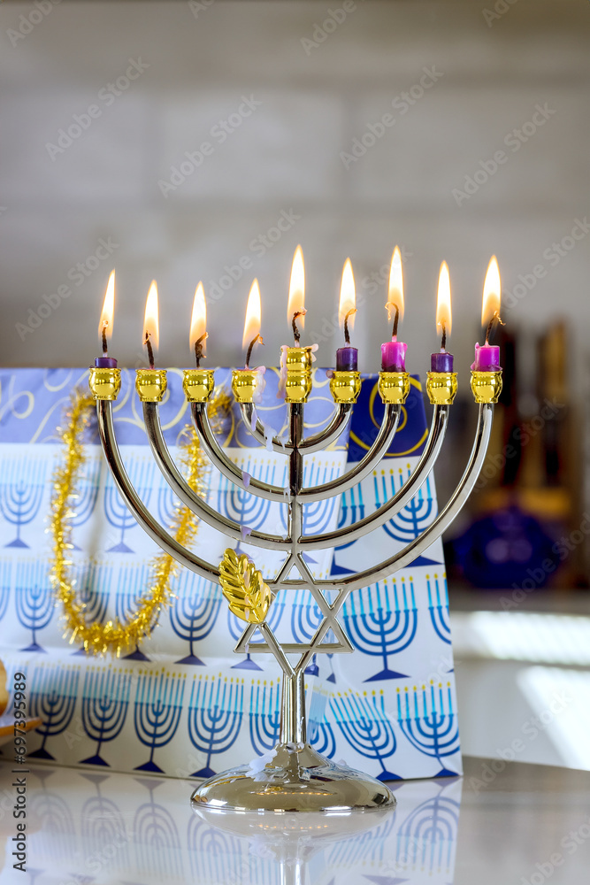 Fototapeta premium Hanukkiah Menorah candle is lit during traditional celebration of Hanukkah it is one symbols Jewish religion during this holiday