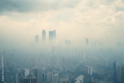 Aerial view of modern city with skyscrapers in fog.