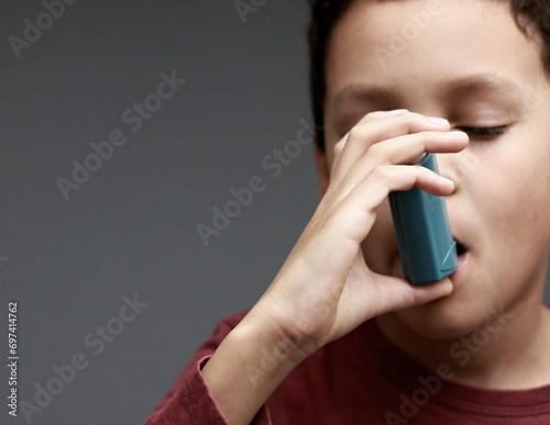 child with flu and inhaler respiratory puff on grey background with people stock image stock photo  photo