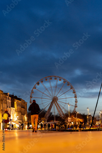 Cityscape of La rochelle with towers and great wheel, France. night shot © mathilde
