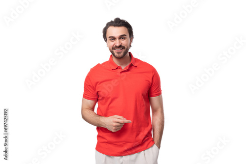 young smart brunette man with a beard is dressed in a red T-shirt on a white background with copy space