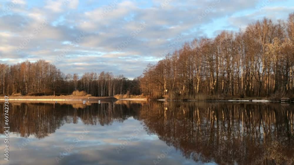 Golden hour, beautiful autumn landscape, river, forest, clouds, reflection in water, silence Golden hour, beautiful autumn landscape, river, forest, clouds, reflection in water, silence