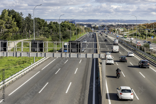 Access highway to the city of Madrid with some traffic in both directions