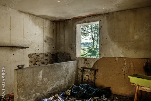 A room in an abandoned building full of waste, dirt and everything in a deplorable state photo
