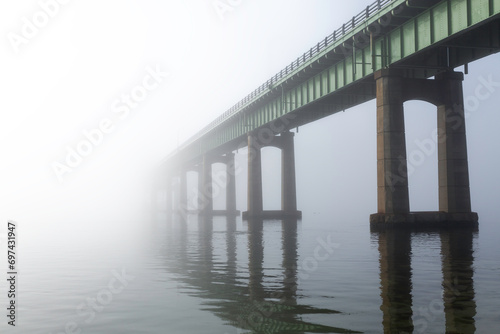 A bridge vanishes into fog and mist. Located at Captree State Park, Long Island New York. The bridge leads to Robet Moses State Park on Fire Island © Michael Carni