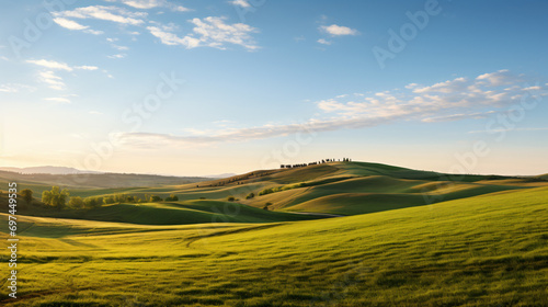A panoramic landscape of rolling hills at dusk with long shadows and a tranquil atmosphere.