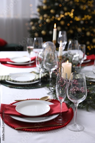Christmas table setting with festive decor and dishware, space for text