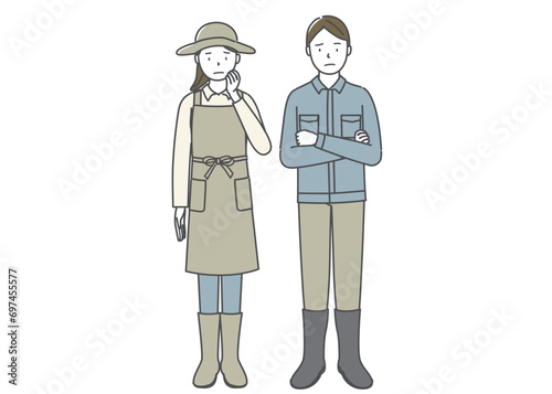 困った表情の農家の夫婦