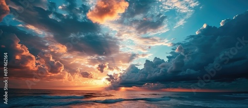 Colorful sunset over the ocean with clouds in various shades.