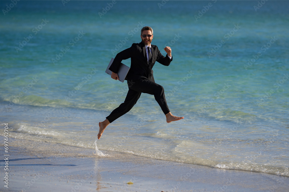 Summer business. Freelancer on summer sea beach. Business man in wet suit in sea water. Crazy business vacation. Funny businessman with laptop in formal wear near tropical beach. Hot business summer. Summer business. Freelancer on summer sea beach. Business man in wet suit in sea water. Crazy business vacation. Funny businessman with laptop in formal wear near tropical beach. Hot business summer.