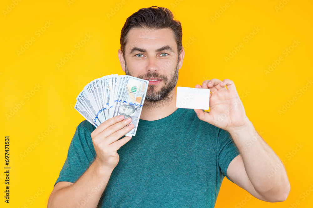 Good payment. Handsome man holding money isolated over grey studio. Money in dollar banknotes. Pile of cash, finance, investment and money saving. Good payment. Handsome man holding money isolated over grey studio. Money in dollar banknotes. Pile of cash, finance, investment and money saving.