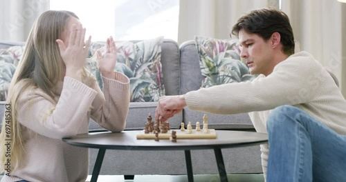 Couple, chess game or playing in home with strategy, plan or mental health for brain power. Happy woman, loser or smart man in a fun board match for problem solving or challenge to relax in apartment photo