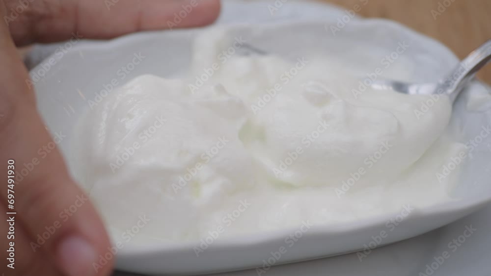 spoon pick fresh yogurt in a bowl on table spoon pick fresh yogurt in a bowl on table
