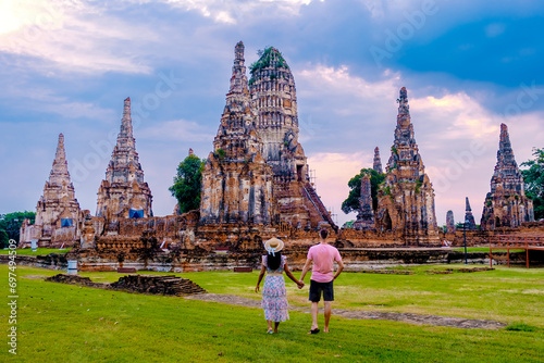 Men and Women with hat tourists visit Ayutthaya Thailand at Wat Chaiwatthanaram during sunset, Couple on a trip to the old city of Ayutthaya at sunset © Fokke Baarssen