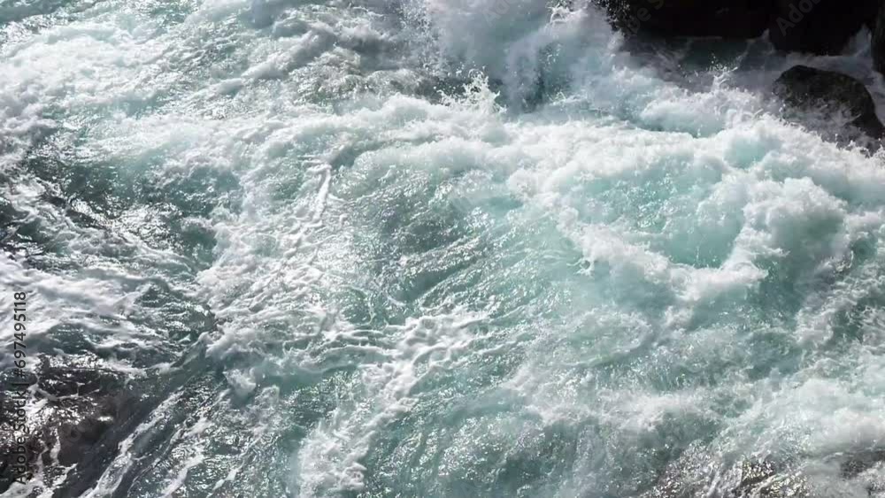 Green energy. Renewable energy sources. Perpetual motion machine. Power of nature. Water element. Limited natural resources. Sea waves break into white foam on the coastal rocks Green energy. Renewable energy sources. Perpetual motion machine. Power of nature. Water element. Limited natural resources. Sea waves break into white foam on the coastal rocks