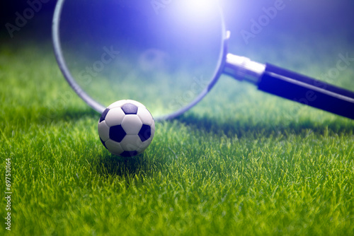 football score result prediction , online soccer betting , ball with magnufying glass on green field © janews094