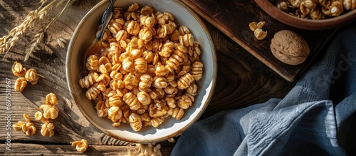 Healthy cereal with honey-coated puffed wheat in a top-down perspective. photo