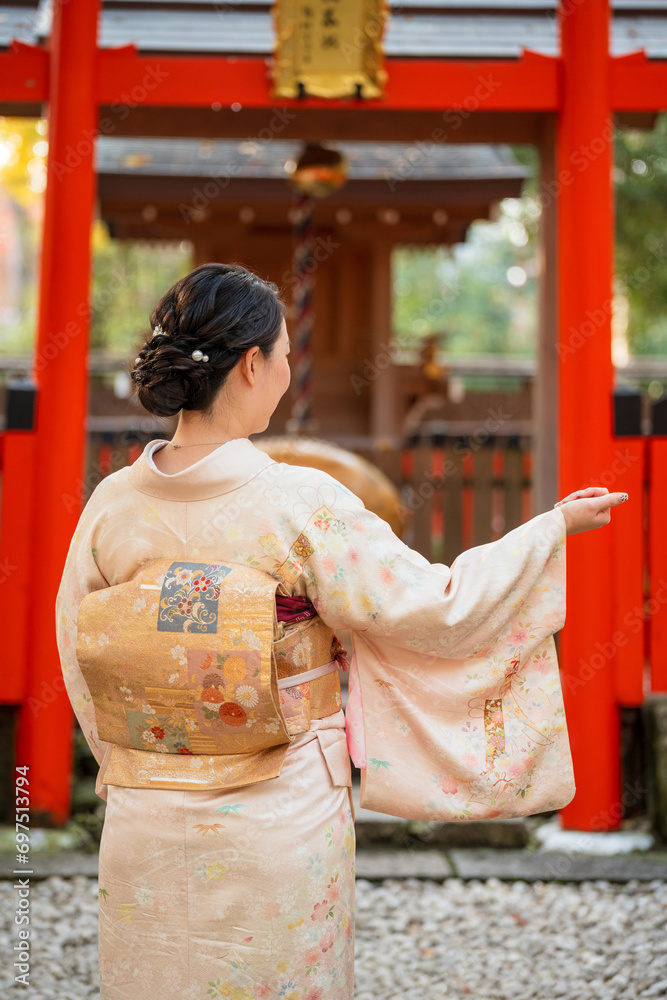 Japanese Female Kimono portrait photography. Kyoto, Japan. Japanese traditional Shrine Torii in the background.