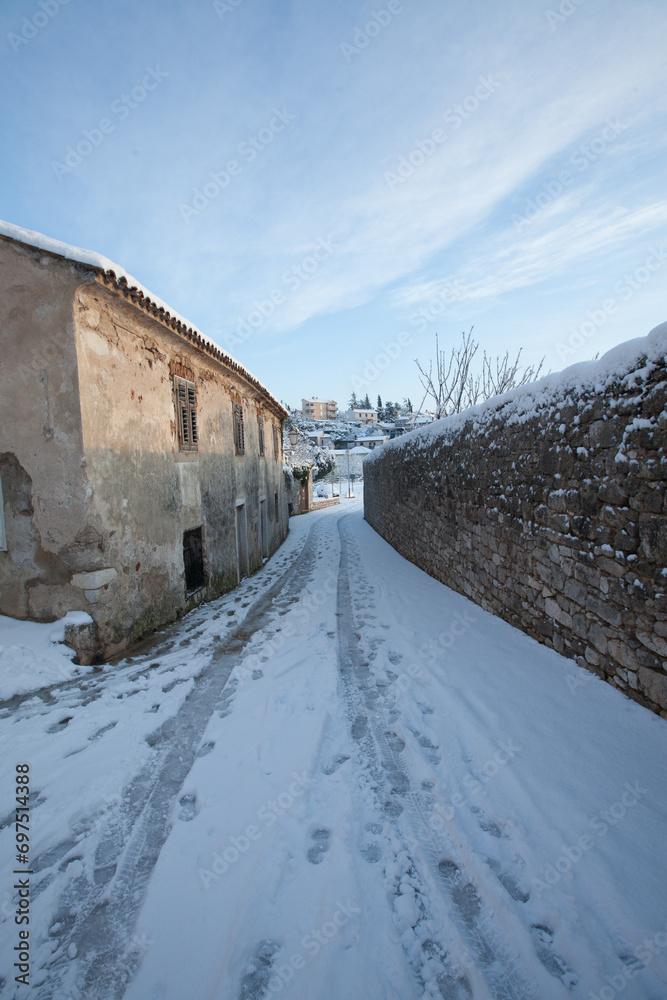 snow covered road in an old town