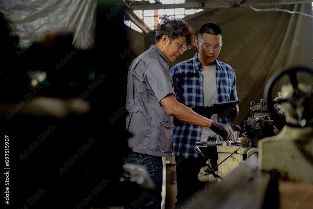 Men are inspecting steel parts for machine installation. team of teacher and student are learning to use heavy machines in steel factory. workers cooperate while doing quality control of manufactured. Men are inspecting steel parts for machine installation. team of teacher and student are learning to use heavy machines in steel factory. workers cooperate while doing quality control of manufactured.