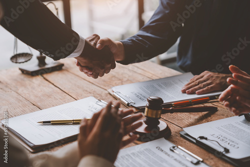 Lawyer shaking hands with businessman, investor in financial agreement, partner congratulating success or lawyer discussing contract agreement. Handshake concept. Agreement. photo