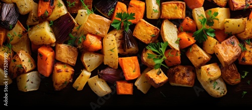 Closeup top view of roasted root vegetables: parsnip, carrot, and sweet potato. photo