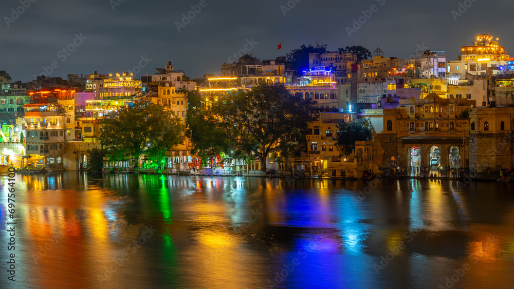 Lit up Building and Cityscape around Lake Pichola in Udaipur Rajasthan India at night