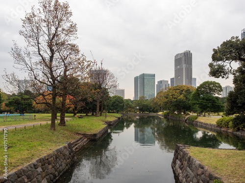 Water in autumn Hamarikyu Gardens in Tokyo Japan with skyscapers on the background