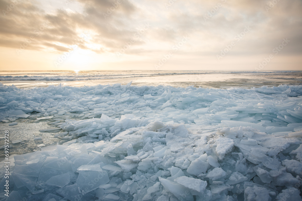 Large pieces of ice near the river bank at sunset Large pieces of ice near the river bank at sunset