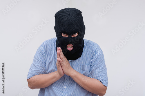 A devious evil man explains his masterplan while rubbing his hands, savoring his plan. Isolated on a white backdrop. photo