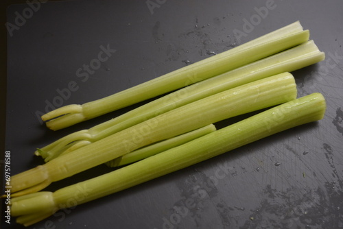 Very healthy and wholesome food  pods  long stems of green angry located on a gray  matte background.