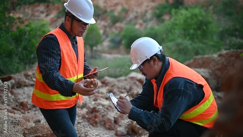 Geologist surveying mine,Explorers collect soil samples to look for minerals. photo