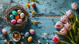 Rustic Easter Composition with Tulips and Decorative Eggs on a Blue Background