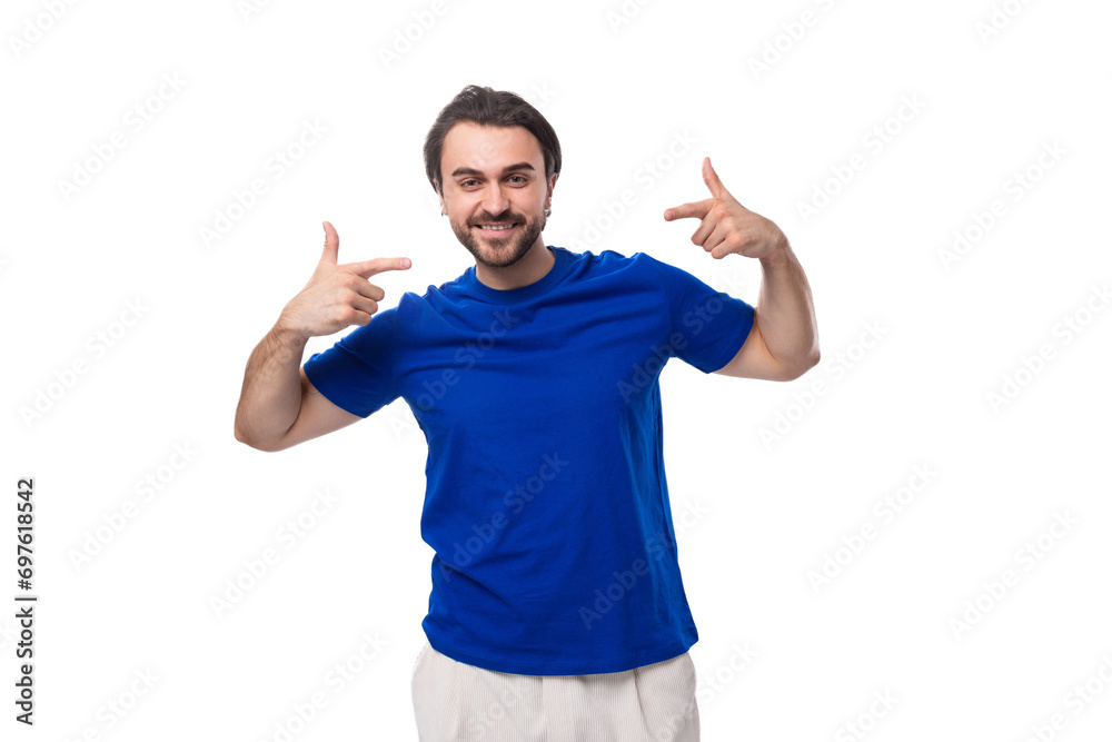 young handsome brunette man with a beard in a blue t-shirt actively gesturing with his hands on a white background with copy space