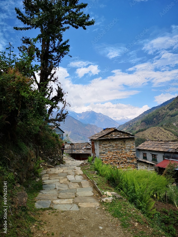 A winding stone path emerges from the rugged mountains, guiding visitors to a village nestled in nature's embrace. A winding stone path emerges from the rugged mountains, guiding visitors to a village nestled in nature's embrace.
