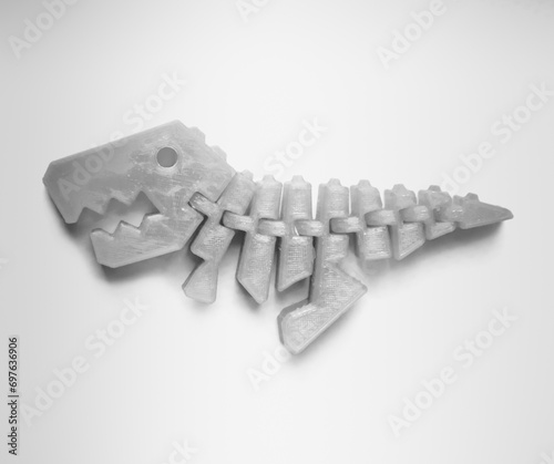 Bright light pink object in shape of dinosaur toy printed on 3d printer isolated on white background. Fused deposition modeling, FDM. Concept modern progressive additive technology for 3d printing.
