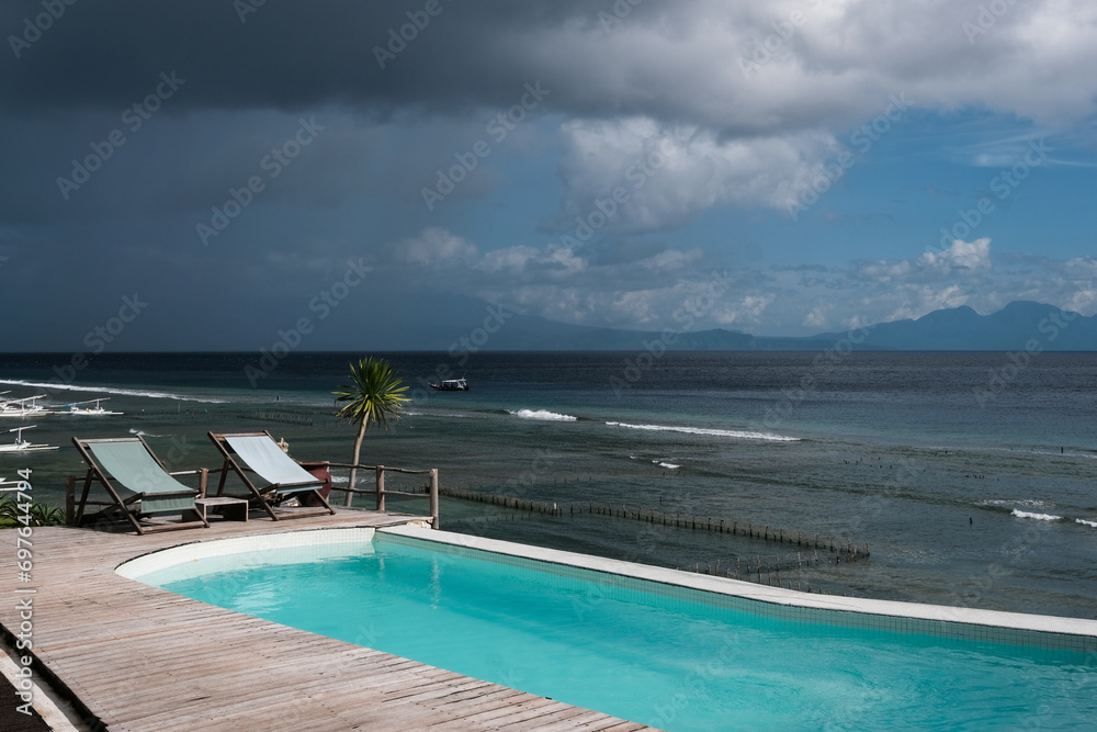 View of a restaurant swimming pool before the thunderstorm. Nusa Penida, Indonesia.