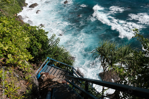 Stairs leading to Guyangan Waterfall on sunny day. Nusa Penida, Indonesia. photo