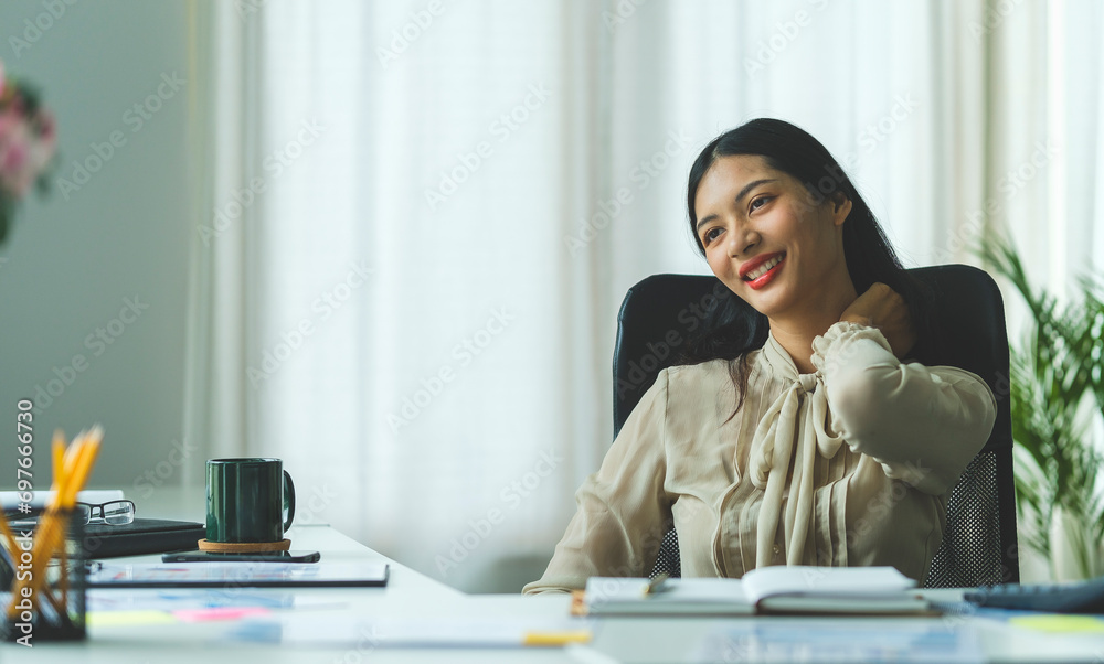 Satisfied asian young woman relaxing at her workplace and looking through the window at office. Satisfied asian young woman relaxing at her workplace and looking through the window at office.