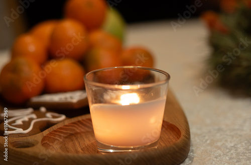 Christmas composition with candle and tangerines