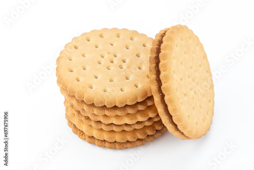 Sandwich cookies lie one on top of the other, isolated on a white background.