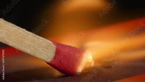 4K - a matchstick burning with matchbox. Extreme close-up photo