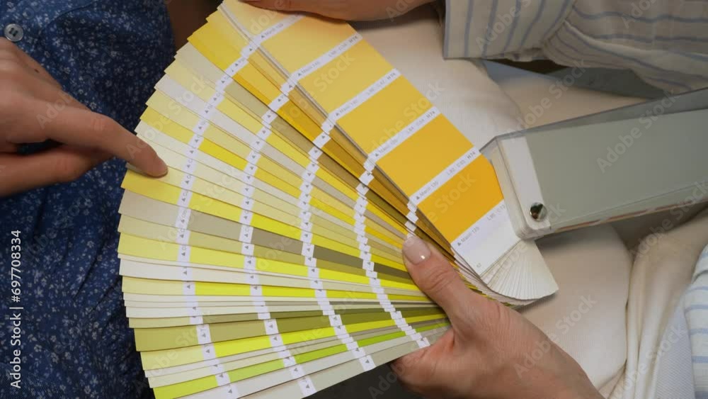 Female desiner and customer holding paint color swatches. Female hand ...
